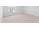 Bright bedroom features neutral carpet, and a window with views of the backyard at 7018 Deanston Dr, Ravenel, SC 29470