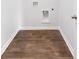 Neutral laundry room showing hookups, dark vinyl flooring, and white trim at 7018 Deanston Dr, Ravenel, SC 29470