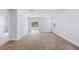 Living room with a sliding glass door leading to the backyard and wood look flooring at 7018 Deanston Dr, Ravenel, SC 29470