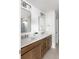 Modern bathroom with dual sinks, sleek mirrors, and stylish wooden cabinetry, providing ample storage and a clean aesthetic at 711 Alma Square Dr, Moncks Corner, SC 29461