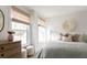 Bright bedroom featuring charming windows with patterned blinds, a decorative wall piece, and a cozy bed at 711 Alma Square Dr, Moncks Corner, SC 29461