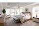 Airy bedroom filled with natural light, featuring a stylish chandelier, plush bed, and large windows with sheer curtains at 711 Alma Square Dr, Moncks Corner, SC 29461