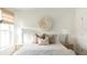 Bright bedroom featuring a cozy bed with decorative pillows and a circular wall decoration at 711 Alma Square Dr, Moncks Corner, SC 29461