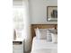 Bright bedroom featuring a rattan headboard, white linens, and a white bedside table at 711 Alma Square Dr, Moncks Corner, SC 29461