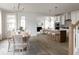 Open-concept dining area showcasing a modern kitchen, dining table, and hardwood floors at 711 Alma Square Dr, Moncks Corner, SC 29461