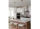 Bright, spacious kitchen with white cabinets, an island with seating, and stainless steel appliances at 711 Alma Square Dr, Moncks Corner, SC 29461