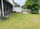 Lush backyard with green grass, shed and wooden privacy fence at 715 Hampton St, Walterboro, SC 29488