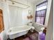 Bathroom featuring a clawfoot tub, toilet, and sink under a window at 715 Hampton St, Walterboro, SC 29488