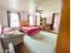 Spacious bedroom with plush green carpet, ceiling fan, 3 windows, and furniture at 715 Hampton St, Walterboro, SC 29488