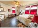 Bright bedroom with hardwood floors and red curtains at 715 Hampton St, Walterboro, SC 29488