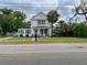 Charming two-story home with a cozy front porch, lush landscaping, and mature palm trees at 715 Hampton St, Walterboro, SC 29488