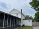 Exterior view of home features a screened in porch and a detached garage and yard at 715 Hampton St, Walterboro, SC 29488