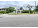Traditional two-story home with manicured lawn, front porch and mature landscaping at 715 Hampton St, Walterboro, SC 29488