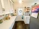 Country kitchen featuring lots of cabinet space, long counters, and a back door entrance to the home at 715 Hampton St, Walterboro, SC 29488