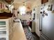 Vintage kitchen featuring stainless appliances, a small table and chairs, with long counters and storage shelves at 715 Hampton St, Walterboro, SC 29488