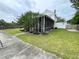 The screened porch wraps around the side of the home and has a lovely landscaped border at 715 Hampton St, Walterboro, SC 29488