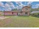 Spacious backyard with healthy grass, patio area, and mature trees at 7791 Peppercorn Ln, North Charleston, SC 29420