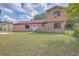 Lush backyard featuring mature trees and healthy green grass at 7791 Peppercorn Ln, North Charleston, SC 29420
