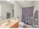 Cozy bathroom featuring vanity sink and tiled shower with decorative curtain at 7791 Peppercorn Ln, North Charleston, SC 29420