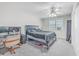 Bedroom featuring modern desk setup, ceiling fan, and natural light from a window at 7791 Peppercorn Ln, North Charleston, SC 29420
