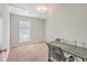 Empty bedroom with neutral walls, carpeted flooring, ceiling fan, desk, and single window at 7791 Peppercorn Ln, North Charleston, SC 29420