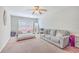 Bright bedroom featuring neutral carpet, couch seating, and large window for natural light at 7791 Peppercorn Ln, North Charleston, SC 29420