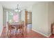 Cozy dining room with wood floors, a chandelier, and views of the backyard at 7791 Peppercorn Ln, North Charleston, SC 29420