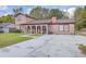 Charming two-story home with red brick accents and a concrete driveway at 7791 Peppercorn Ln, North Charleston, SC 29420