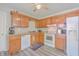 Updated kitchen featuring lots of cabinet space, white appliances, and light gray LVP flooring at 7791 Peppercorn Ln, North Charleston, SC 29420