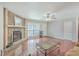 Living room with stone fireplace, hardwood floors, and a large window at 7791 Peppercorn Ln, North Charleston, SC 29420
