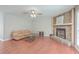Living room with a stone fireplace, hardwood floors, and neutral tones at 7791 Peppercorn Ln, North Charleston, SC 29420