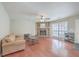 Bright living room featuring a stone fireplace and hardwood floors at 7791 Peppercorn Ln, North Charleston, SC 29420
