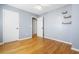 Neutral bedroom featuring hardwood floors, closet, and a bright window at 7932 Riverbirch Ln, North Charleston, SC 29418