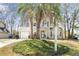 Charming two-story home at 7932 with a well-manicured front yard, complemented by a lovely palm tree at 7932 Riverbirch Ln, North Charleston, SC 29418