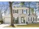 Charming two-story home at 7932 boasts tidy landscaping, complemented by black window shutters at 7932 Riverbirch Ln, North Charleston, SC 29418