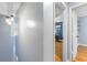 Hallway featuring gray paint, hardwood floors, and access to office space at 7932 Riverbirch Ln, North Charleston, SC 29418