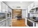 Bright kitchen features white cabinets, stainless steel appliances, and a unique wood accent wall at 7932 Riverbirch Ln, North Charleston, SC 29418