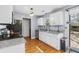 Kitchen with granite countertops, white cabinets, and hardwood floors at 7932 Riverbirch Ln, North Charleston, SC 29418