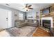 Comfortable living room with fireplace, hardwood floors, and ample seating at 7932 Riverbirch Ln, North Charleston, SC 29418