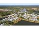 Panoramic aerial view highlighting the community's scenic location near a tranquil lake and wooded areas at 8067 Jack Island Dr, Johns Island, SC 29455