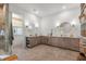 Spacious bathroom with double vanities, tiled floors, walk-in glass shower, and built-in shelves at 8067 Jack Island Dr, Johns Island, SC 29455