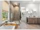 Bright bathroom featuring double vanity, walk-in shower, and soaking tub with views at 8067 Jack Island Dr, Johns Island, SC 29455