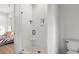 Modern bathroom featuring a glass shower with white tile and a convenient corner seat and a bedroom is visible at 8067 Jack Island Dr, Johns Island, SC 29455