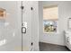Modern bathroom featuring a glass shower with white tile and a view out the window at 8067 Jack Island Dr, Johns Island, SC 29455