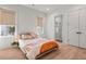 Bright bedroom with natural light, hardwood flooring, and ensuite bathroom with shower at 8067 Jack Island Dr, Johns Island, SC 29455