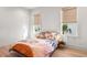 Bright bedroom with natural light, hardwood flooring, and modern minimalist decor at 8067 Jack Island Dr, Johns Island, SC 29455