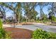 A long concrete driveway leads to the property through mature trees and landscaping at 8067 Jack Island Dr, Johns Island, SC 29455