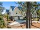 Charming two-story home boasts a metal roof, white siding, and a two-car garage for modern coastal living at 8067 Jack Island Dr, Johns Island, SC 29455