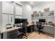 Dedicated home office with two workstations, built-in shelving, and natural light at 8067 Jack Island Dr, Johns Island, SC 29455