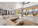Spacious covered patio featuring a comfortable sectional sofa, hanging hammock chairs, and ceiling fans at 8067 Jack Island Dr, Johns Island, SC 29455
